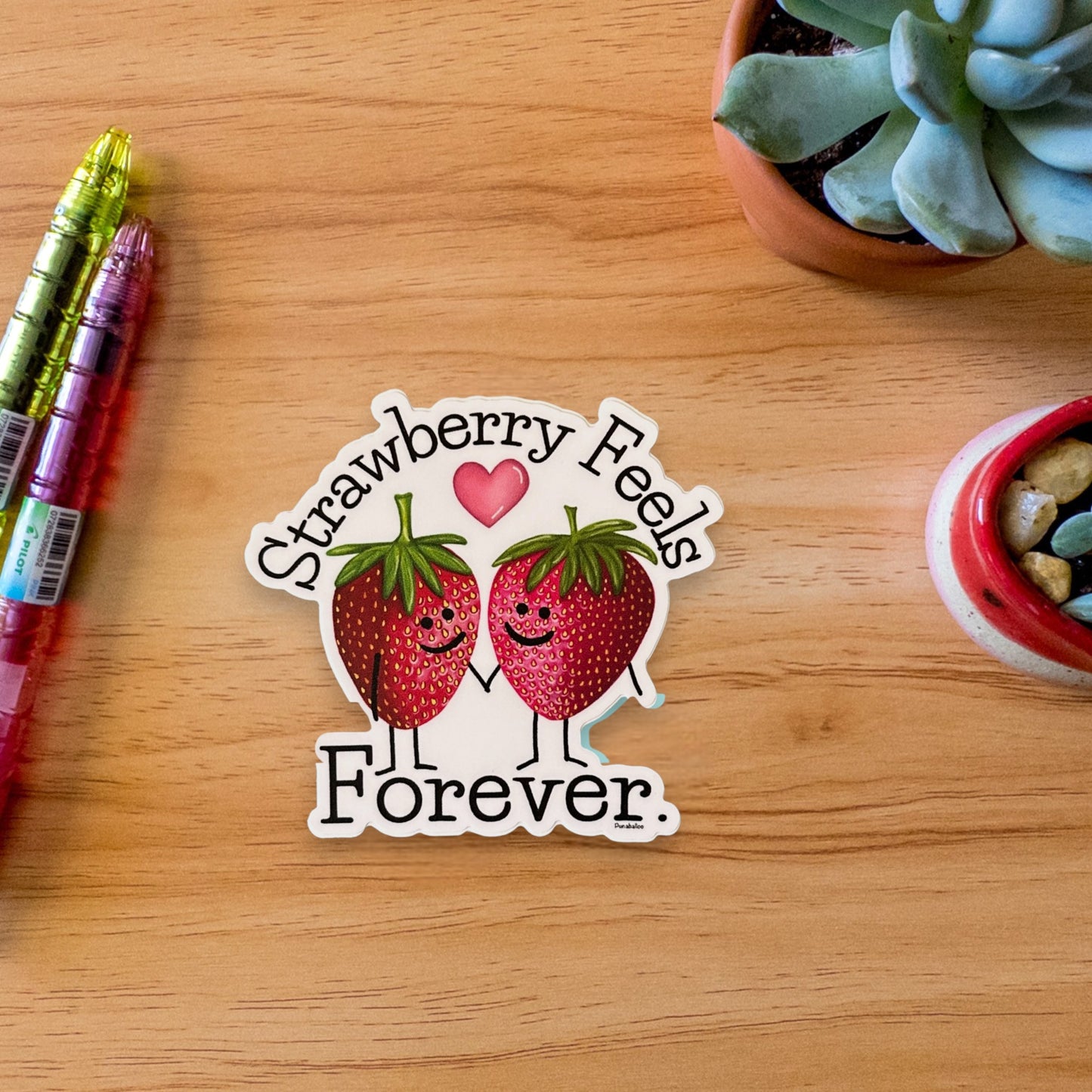 “Strawberry Feels Forever” strawberry sticker — hand-drawn fruit pun design by Punaballoo, waterproof vinyl decal for fruit pun lovers and positivity seekers.