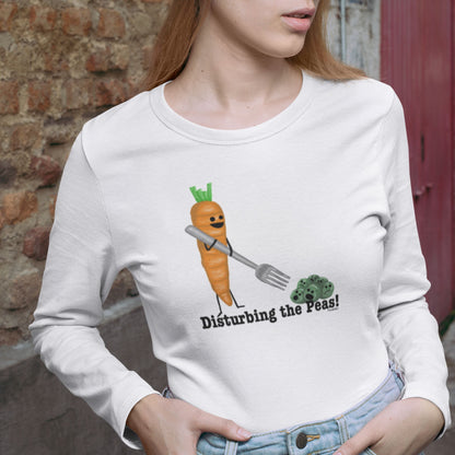 Woman wearing a white Disturbing the Peas long sleeve shirt with a carrot and peas design