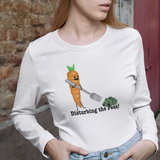 Woman wearing a white Disturbing the Peas long sleeve shirt with a carrot and peas design