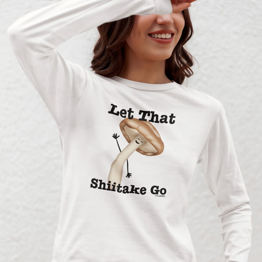 Woman wearing a white Let That Shiitake Go long sleeve shirt with a waving mushroom design
