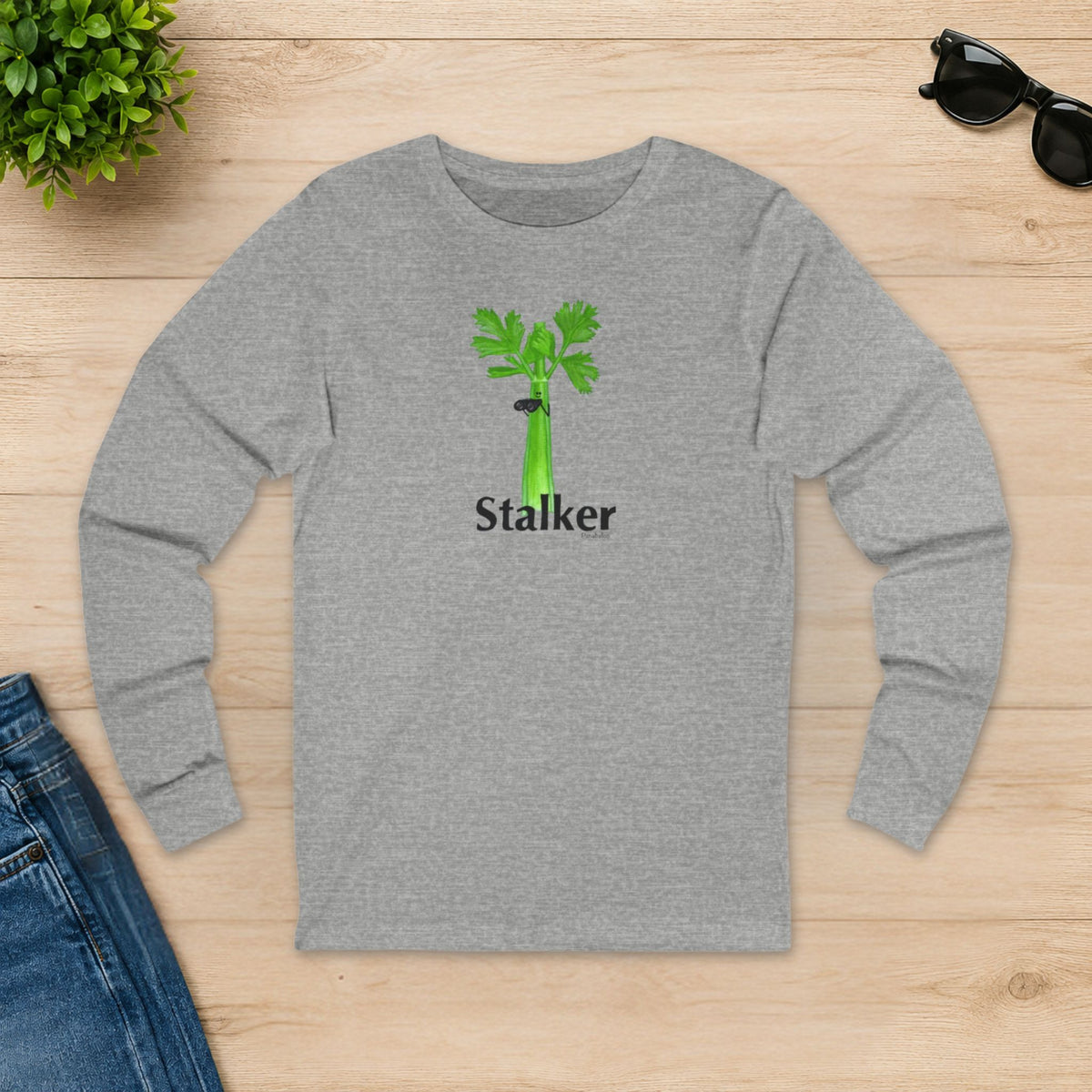 Athletic heather Stalker celery long sleeve shirt laid flat on a wooden table