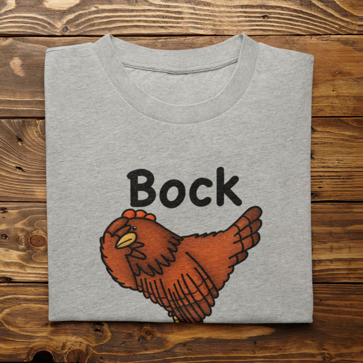 Folded Bock My Life funny chicken graphic t-shirt in athletic heather on a rustic wooden surface
