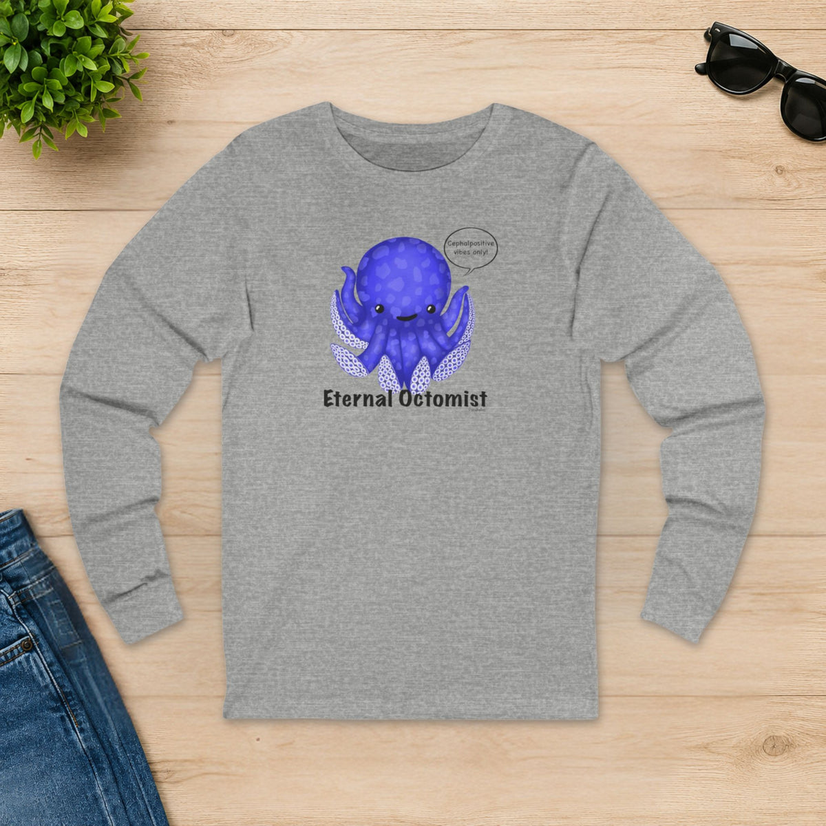 Athletic heather Eternal Octomist long sleeve shirt laid flat on a wooden table