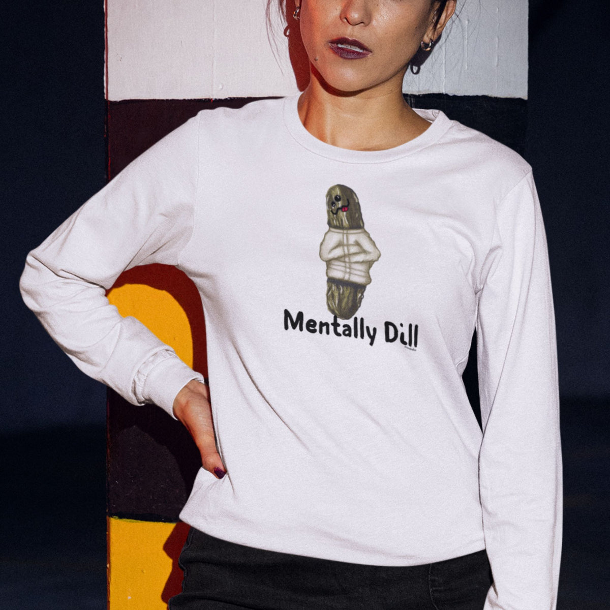 Woman wearing a white Mentally Dill long sleeve shirt with a pickle design