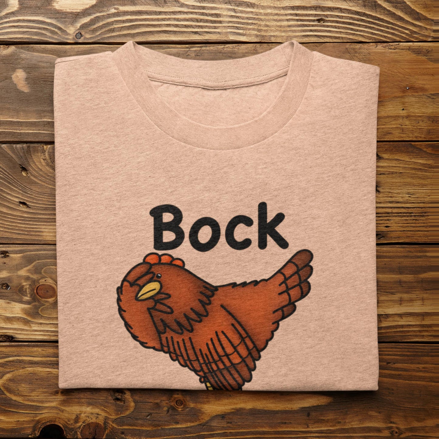 Folded heather peach Bock My Life chicken t-shirt mockup on wood background