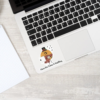 Here We Come A-Waffling sticker — hand-drawn Christmas waffle caroler pun design, waterproof vinyl decal.