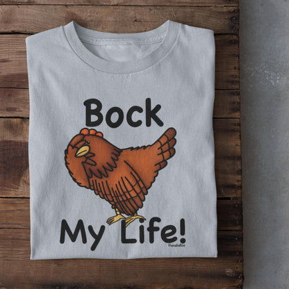 Light Blue folded funny chicken lover t-shirt with Bock My Life pun design on wood background
