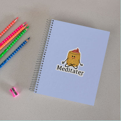 Meditater meditation sticker on a purple spiral notebook with colored pencils