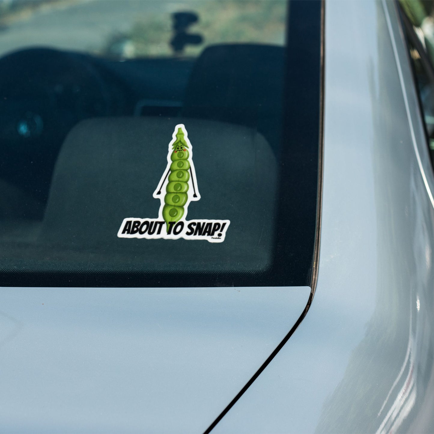 About to Snap snap pea sticker on a car window