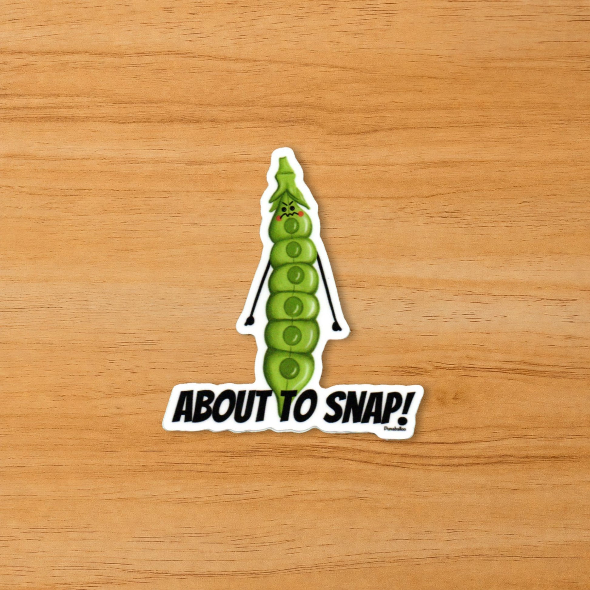 About to Snap vegetable pun sticker on a wood surface