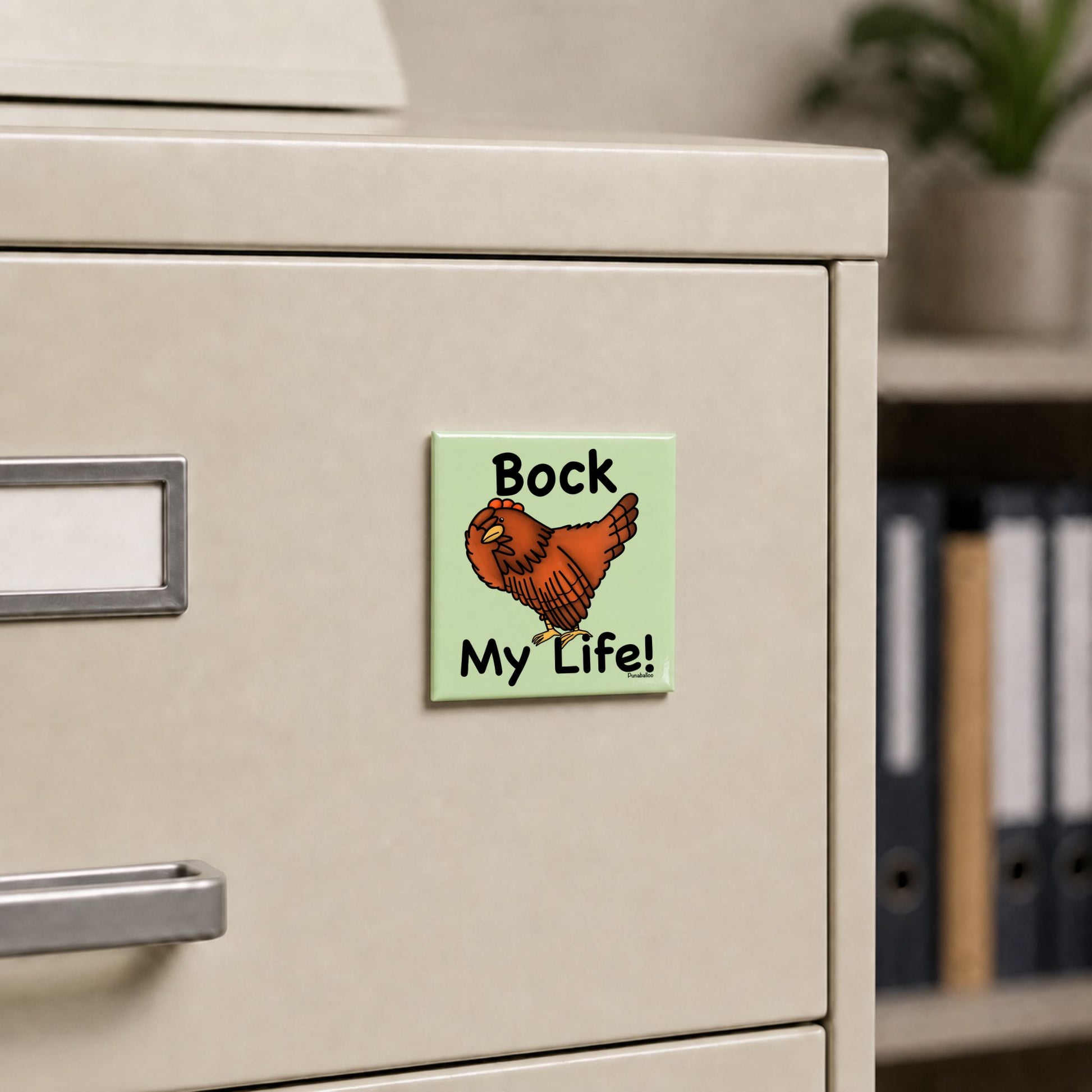 Bock My Life chicken pun magnet on a cream file cabinet