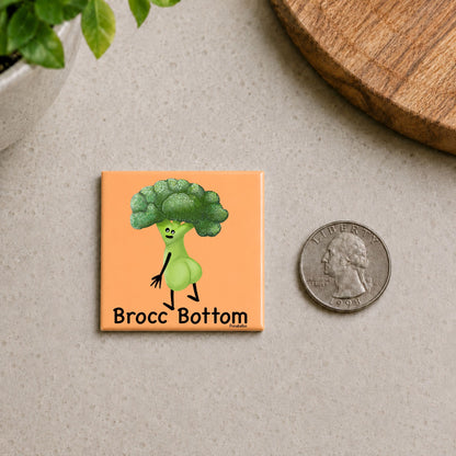 Brocc Bottom broccoli pun magnet on a countertop beside a quarter for size