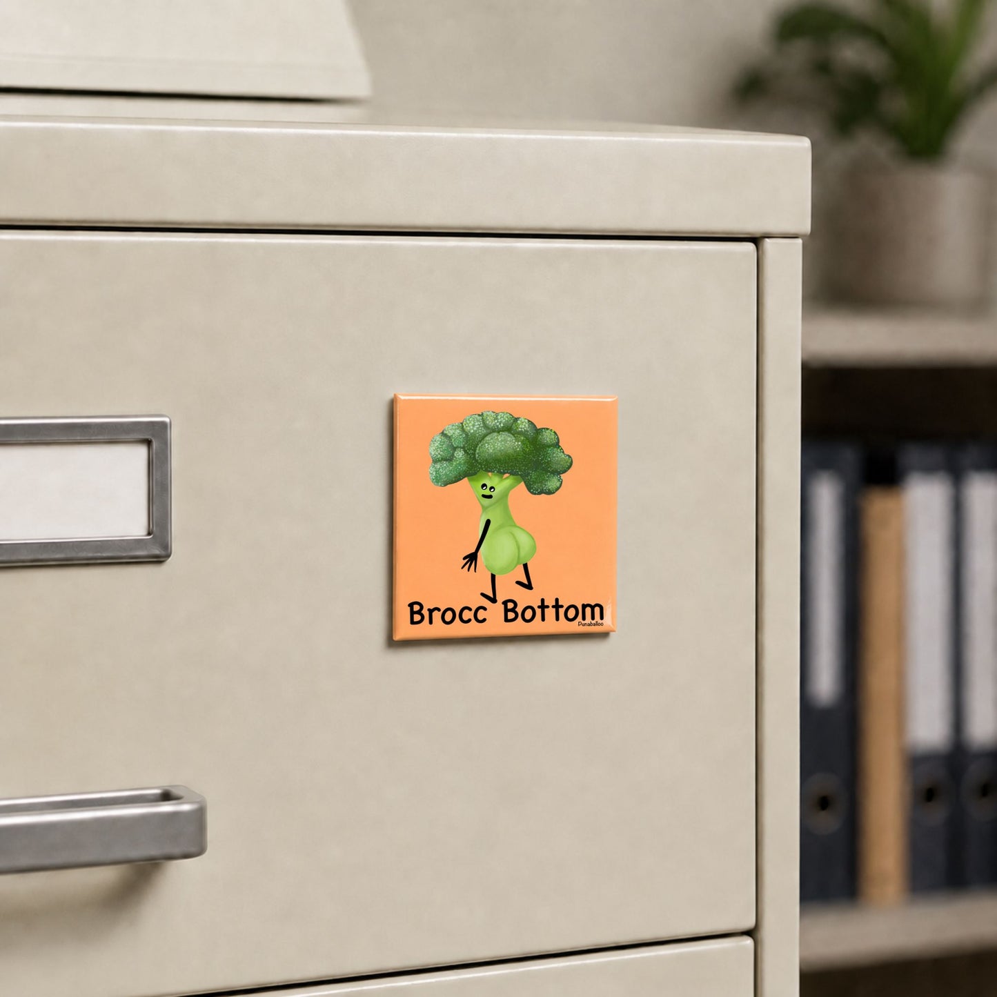Brocc Bottom broccoli pun magnet on a cream file cabinet