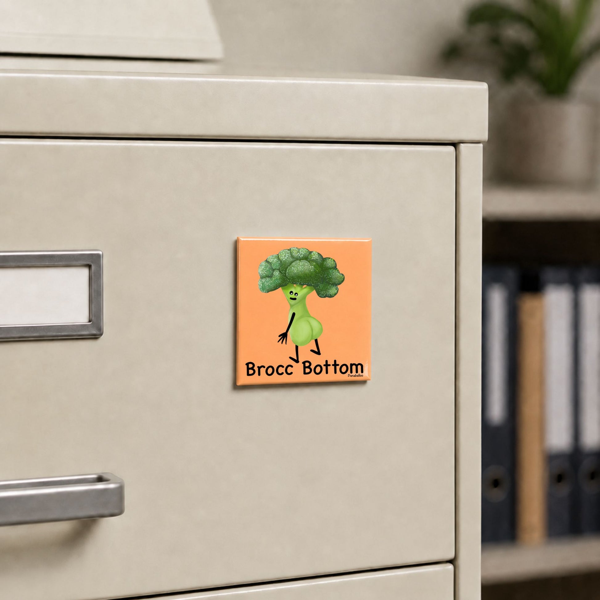 Brocc Bottom broccoli pun magnet on a cream file cabinet