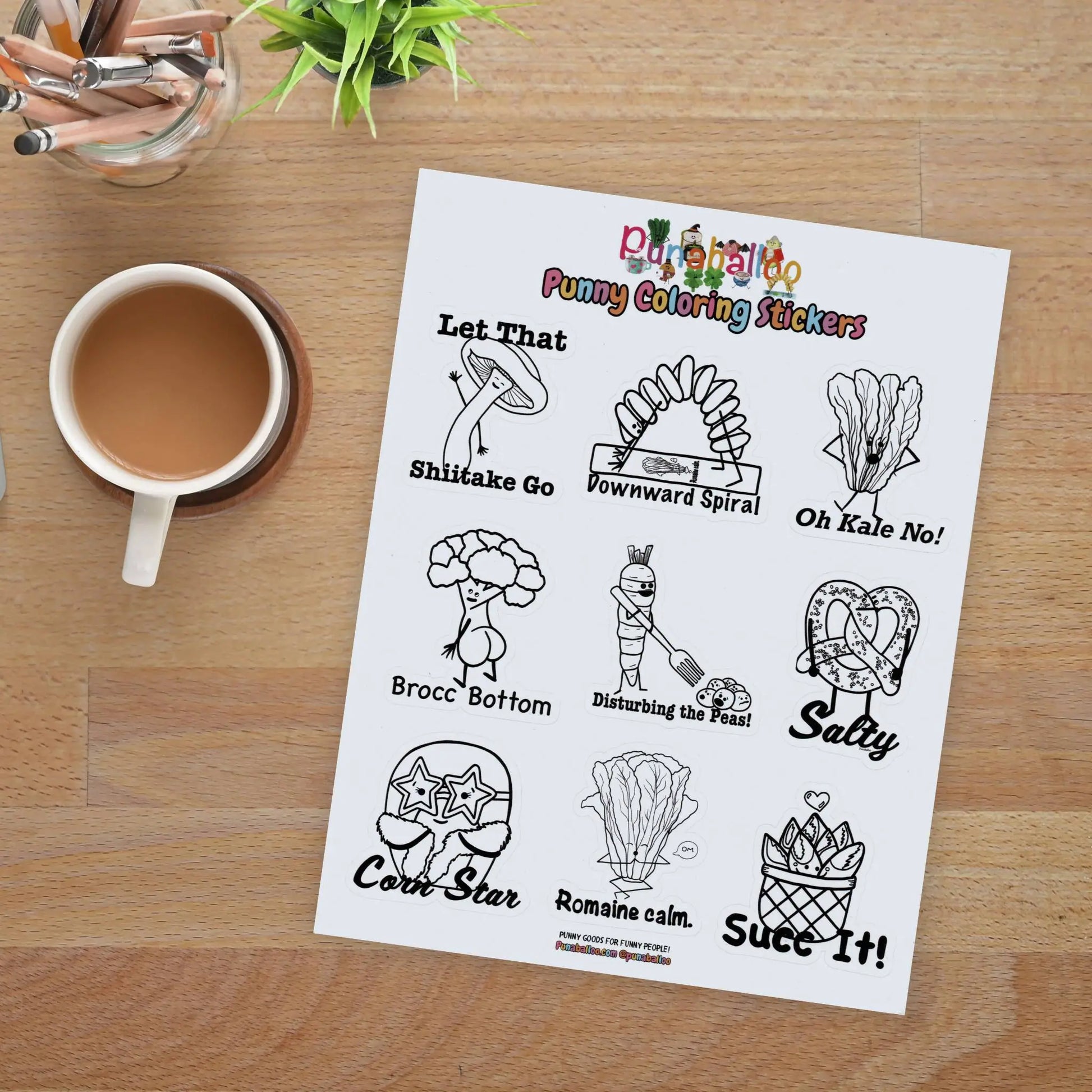 Funny food pun coloring sticker sheet for adults with black and white hand drawn designs on a desk with coffee and pencils