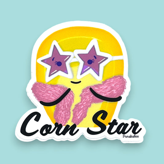 “Corn Star” corn sticker — hand-drawn food pun design by Punaballoo, waterproof vinyl decal for snack lovers and humor fans.