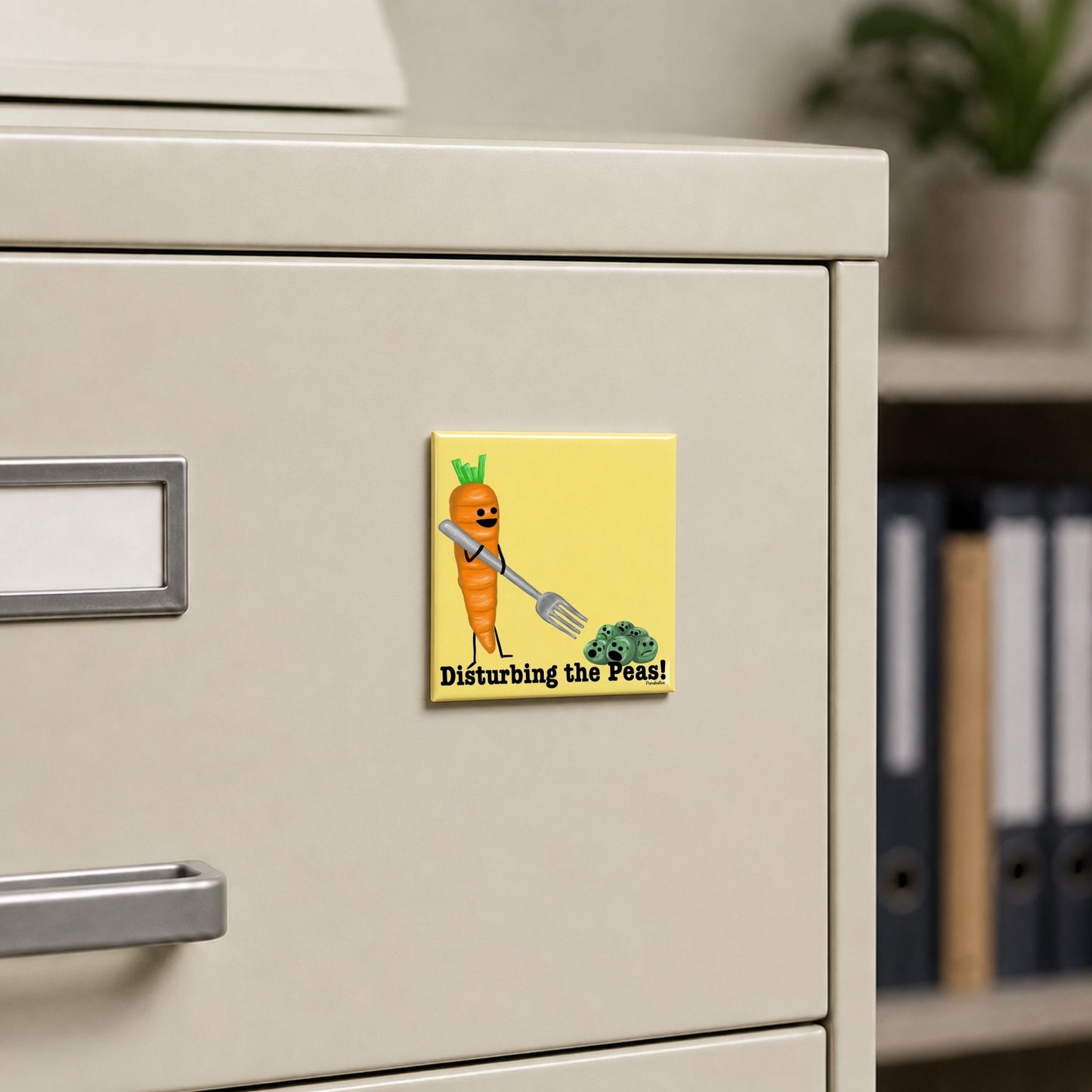 Disturbing the Peas carrot pun magnet on a cream file cabinet