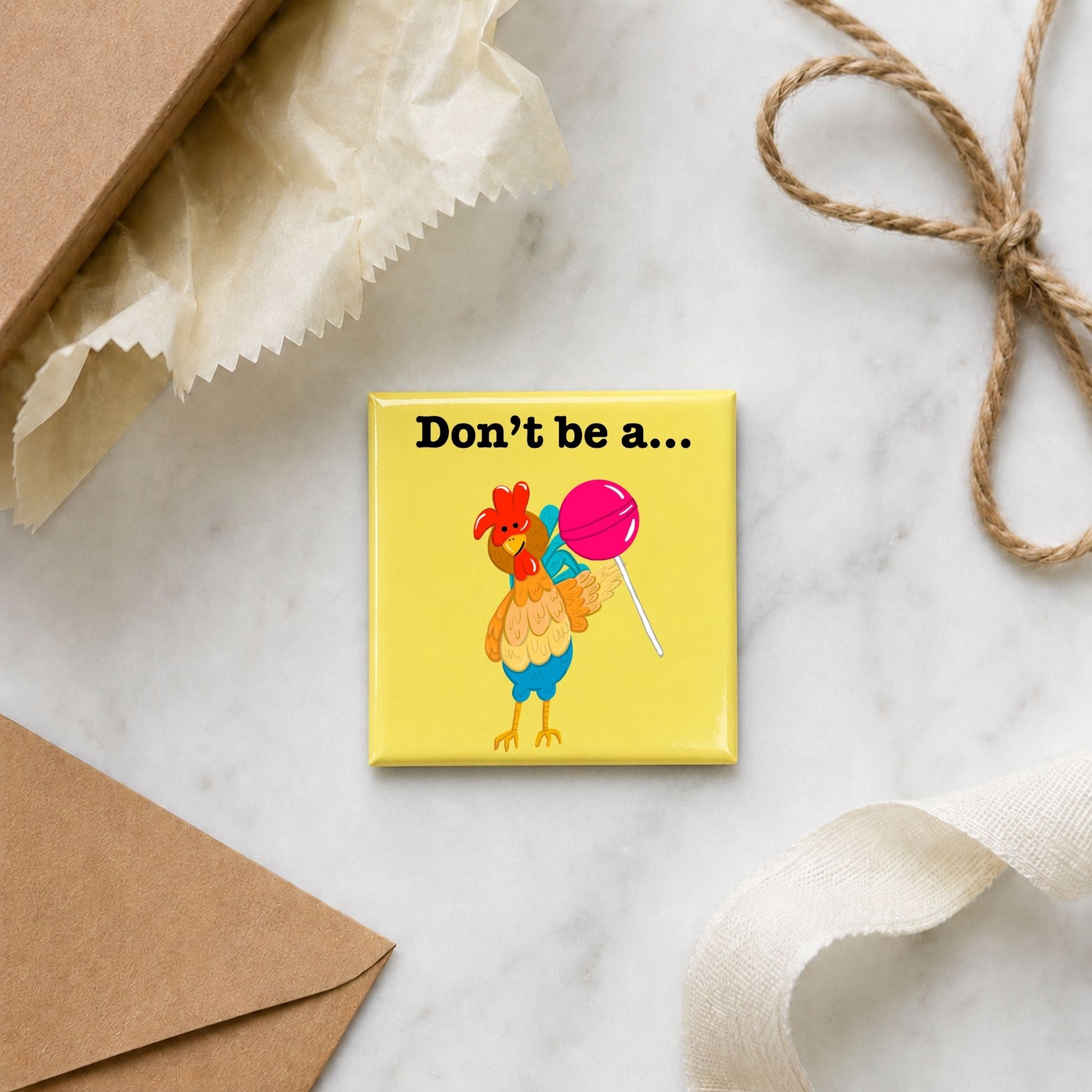 Don’t Be a Cocksucker chicken pun magnet in a gift flat lay