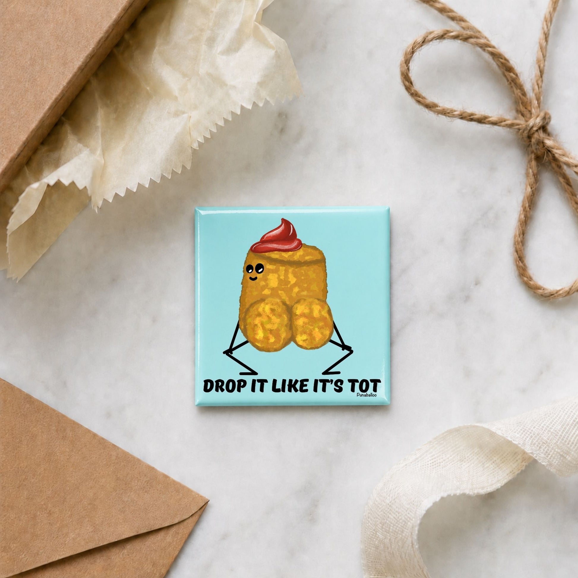 Drop It Like It’s Tot funny potato magnet in a gift flat lay