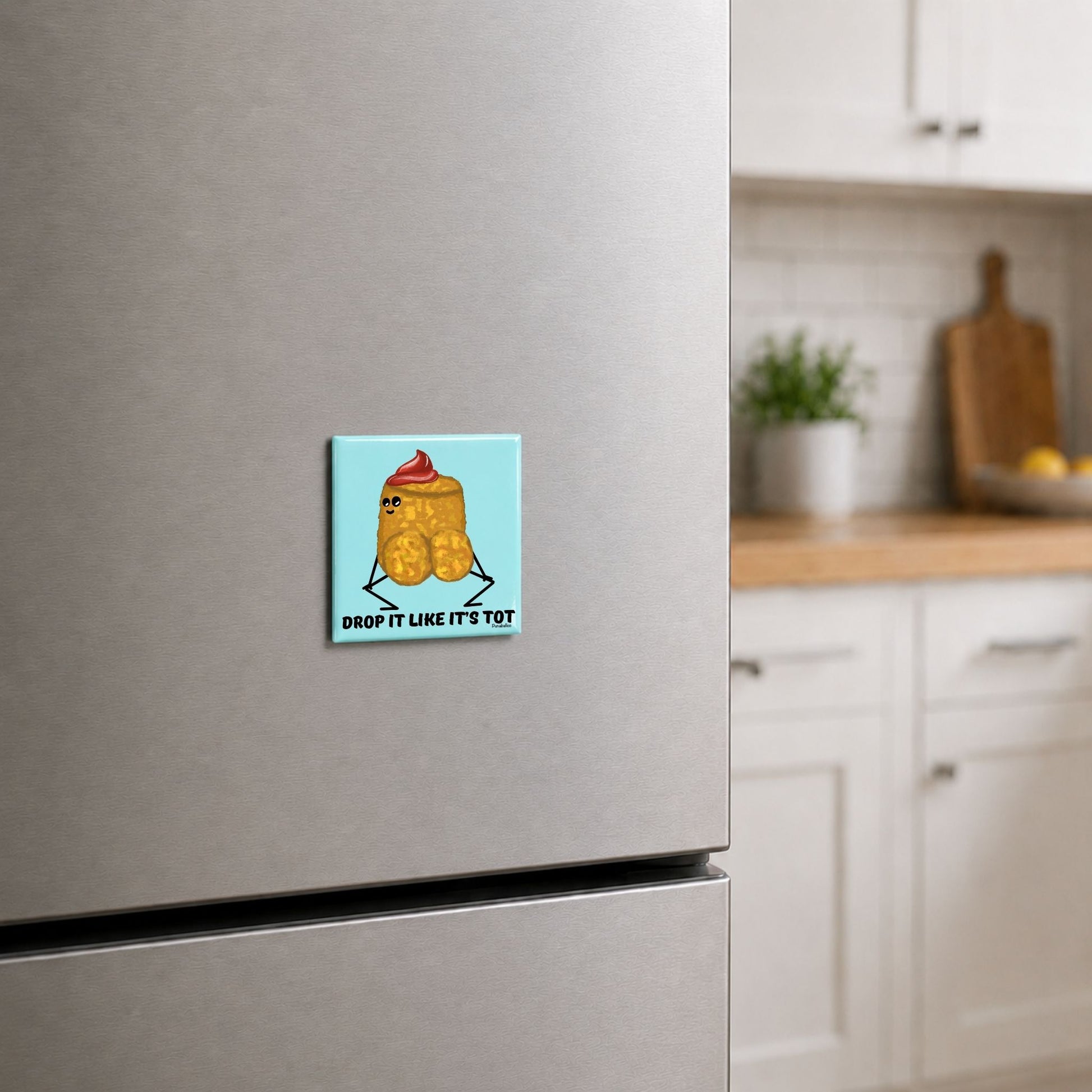 Drop It Like It’s Tot tater tot pun magnet on a kitchen fridge