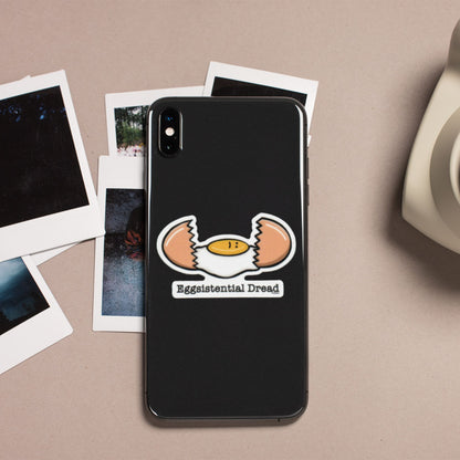 Eggsistential Dread egg pun sticker on a black phone case
