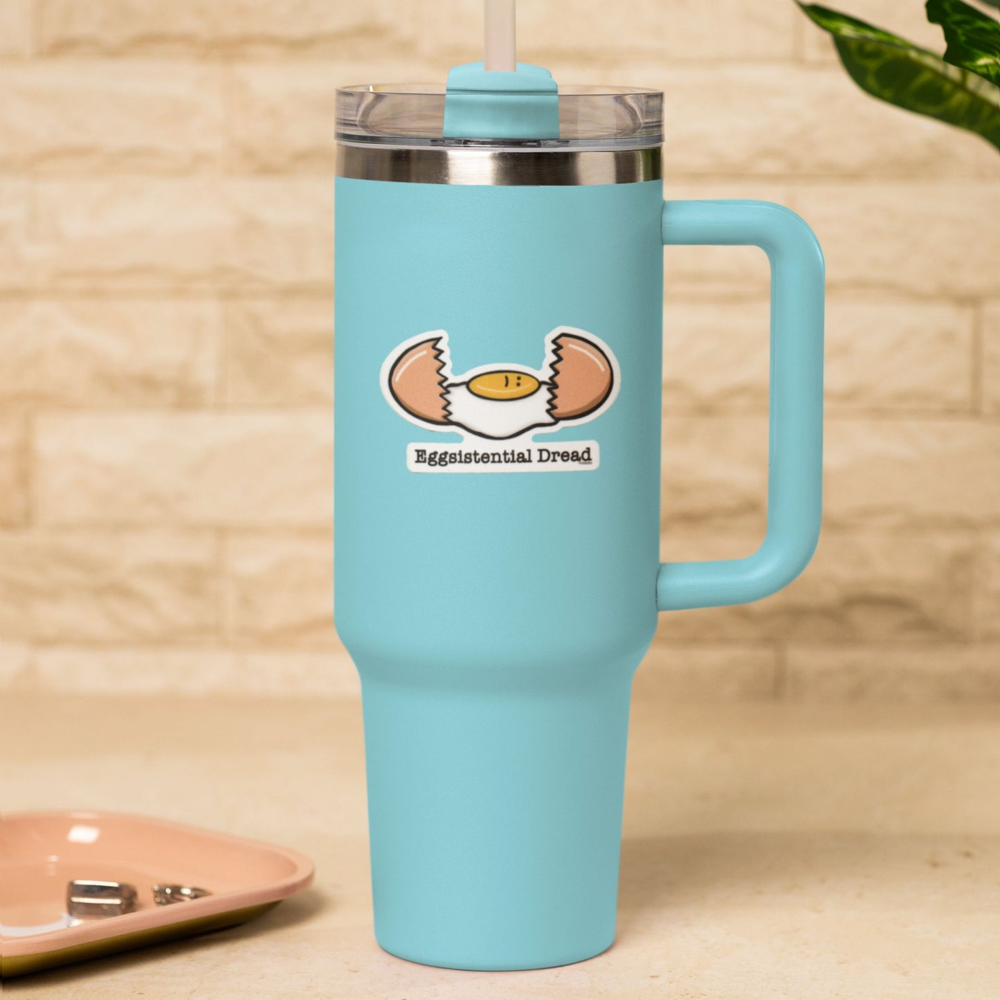 Eggsistential Dread funny food sticker on a blue travel tumbler