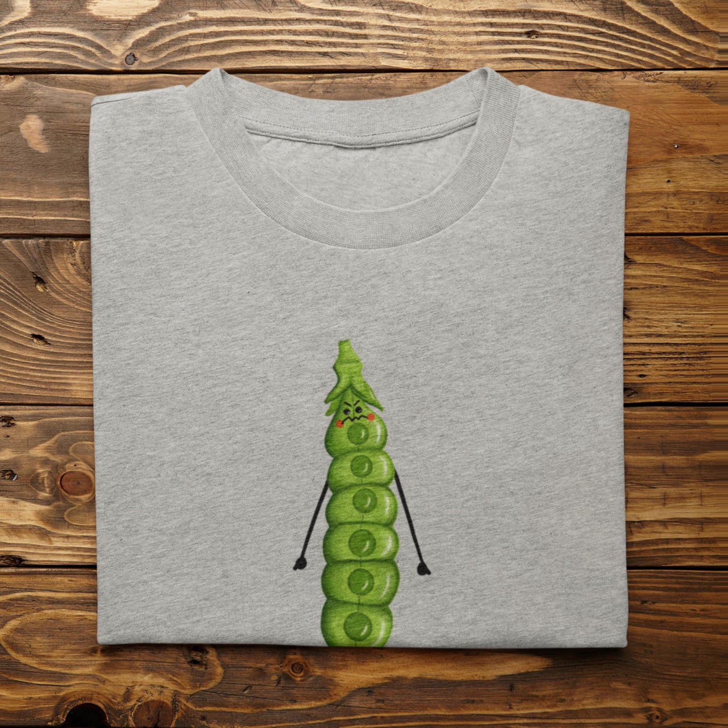 Folded athletic heather I’m About to Snap vegetable pun shirt on rustic wood background