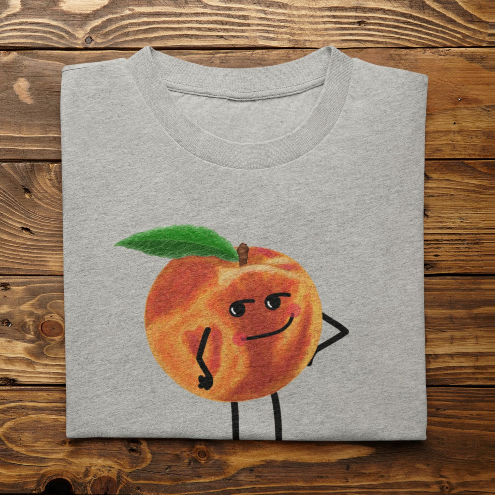 Folded athletic heather Karma Is a Peach funny peach t-shirt on rustic wood background