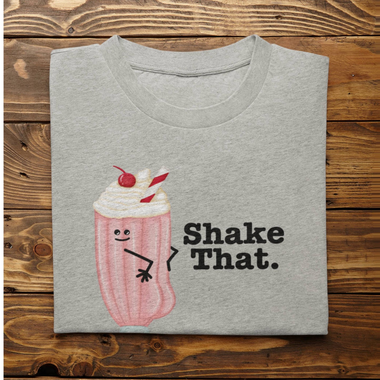 Folded athletic heather Shake That funny ice cream shirt on rustic wood background