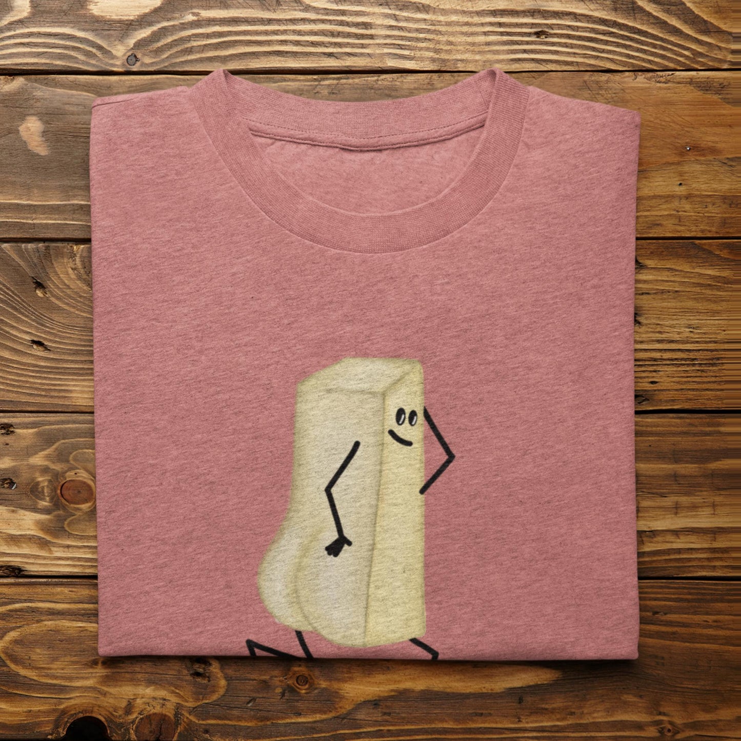 Folded heather mauve You Butter Twerk butter pun t-shirt on rustic wood background