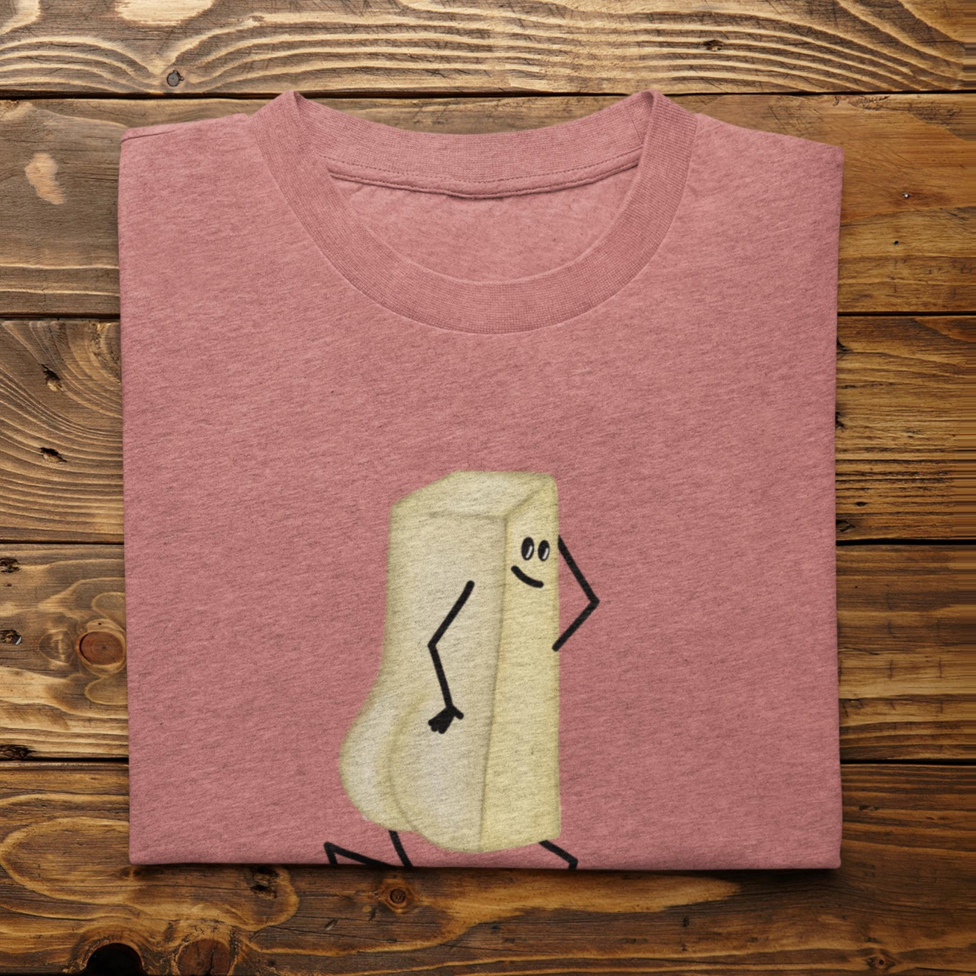 Folded heather mauve You Butter Twerk butter pun t-shirt on rustic wood background