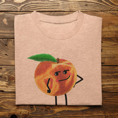 Folded heather peach Karma Is a Peach funny peach shirt on rustic wood background