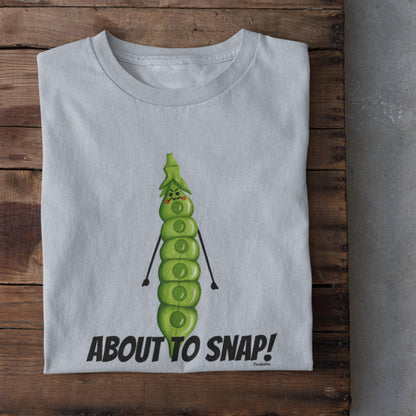 Folded light blue I’m About to Snap pea pun t-shirt on rustic wood background