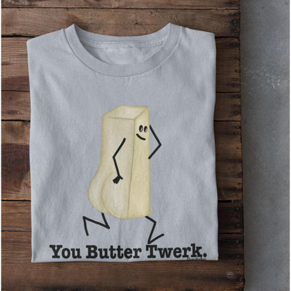 Folded light blue You Butter Twerk funny food pun shirt on rustic wood background