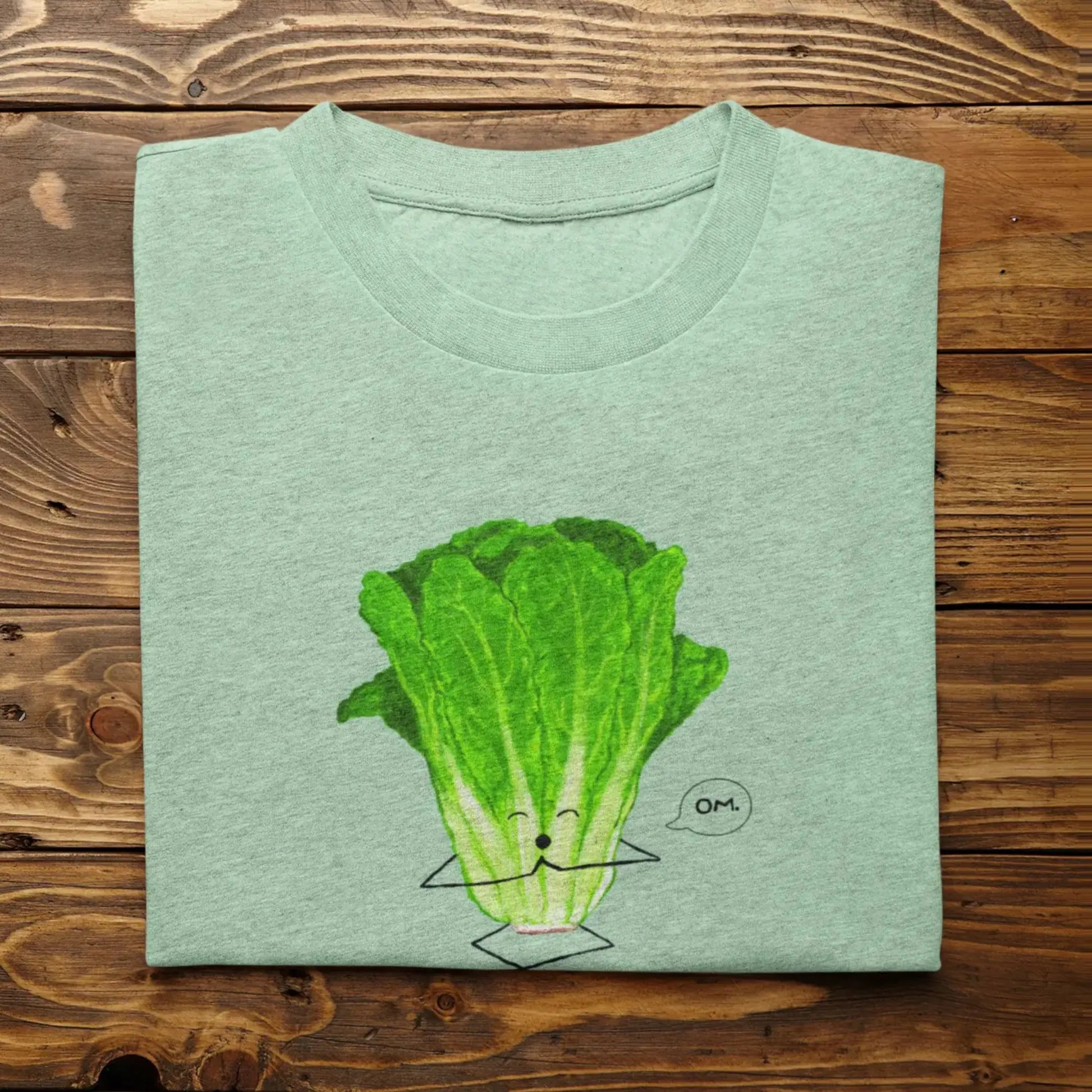 Funny Lettuce Pun T-Shirt “Romaine Calm” flat lay with hand-drawn lettuce pun heather mint