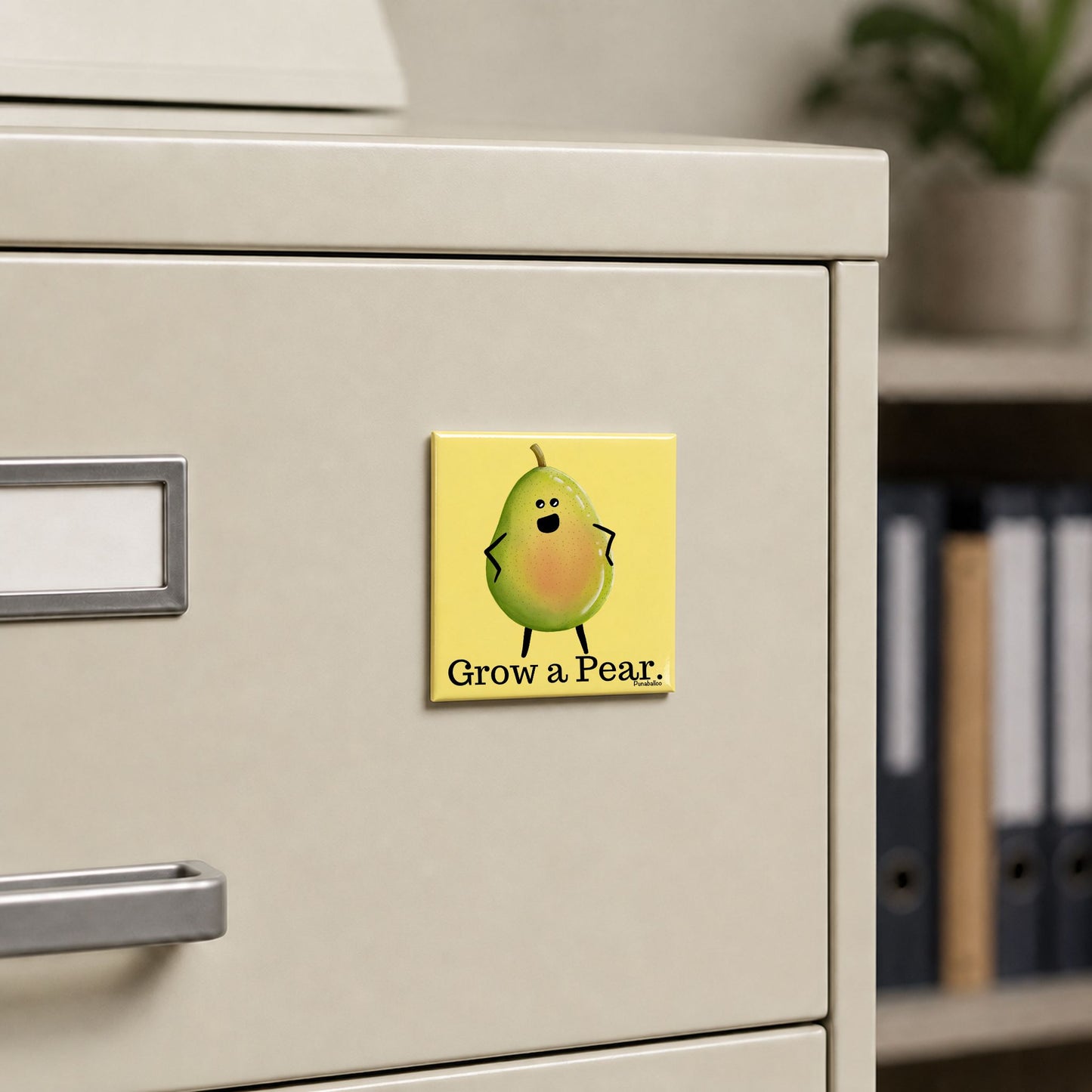 Grow a Pear pear pun magnet on a cream file cabinet