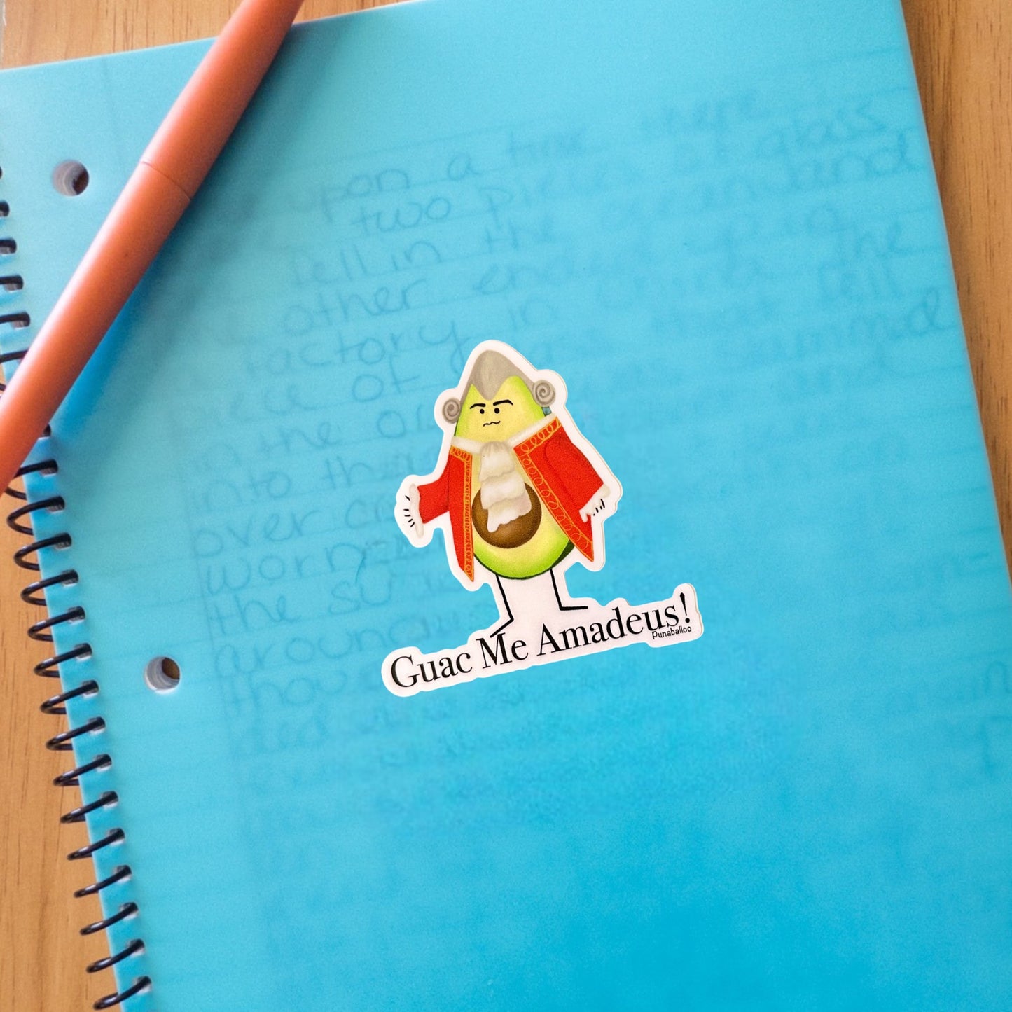 “Guac Me Amadeus” avocado sticker — hand-drawn New Wave food pun design by Punaballoo, waterproof vinyl decal for avocado and music fans.