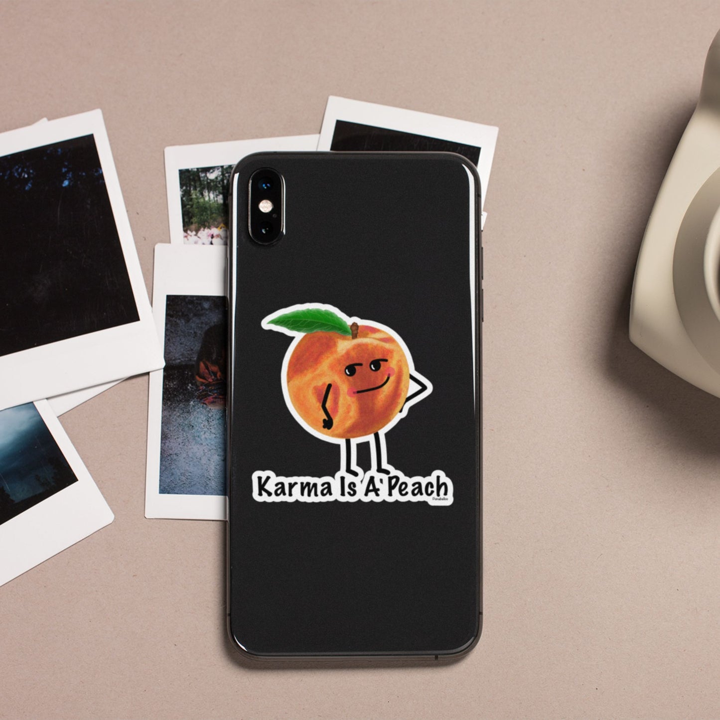 Karma Is a Peach fruit pun sticker on a black phone case