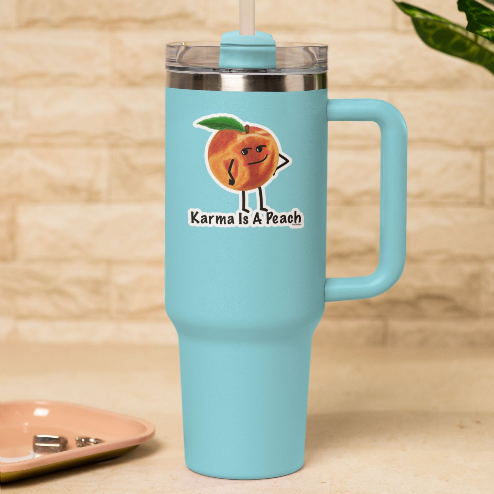 Karma Is a Peach funny fruit sticker on a blue travel tumbler