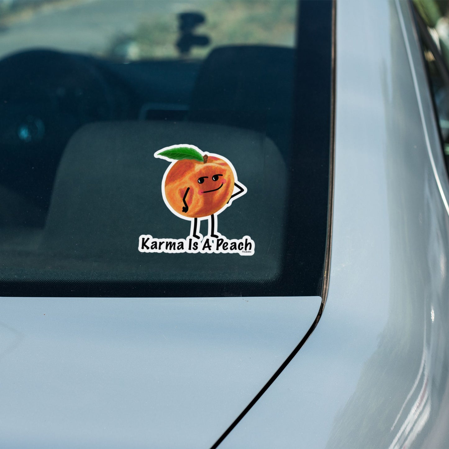 Karma Is a Peach peach pun sticker on a car window