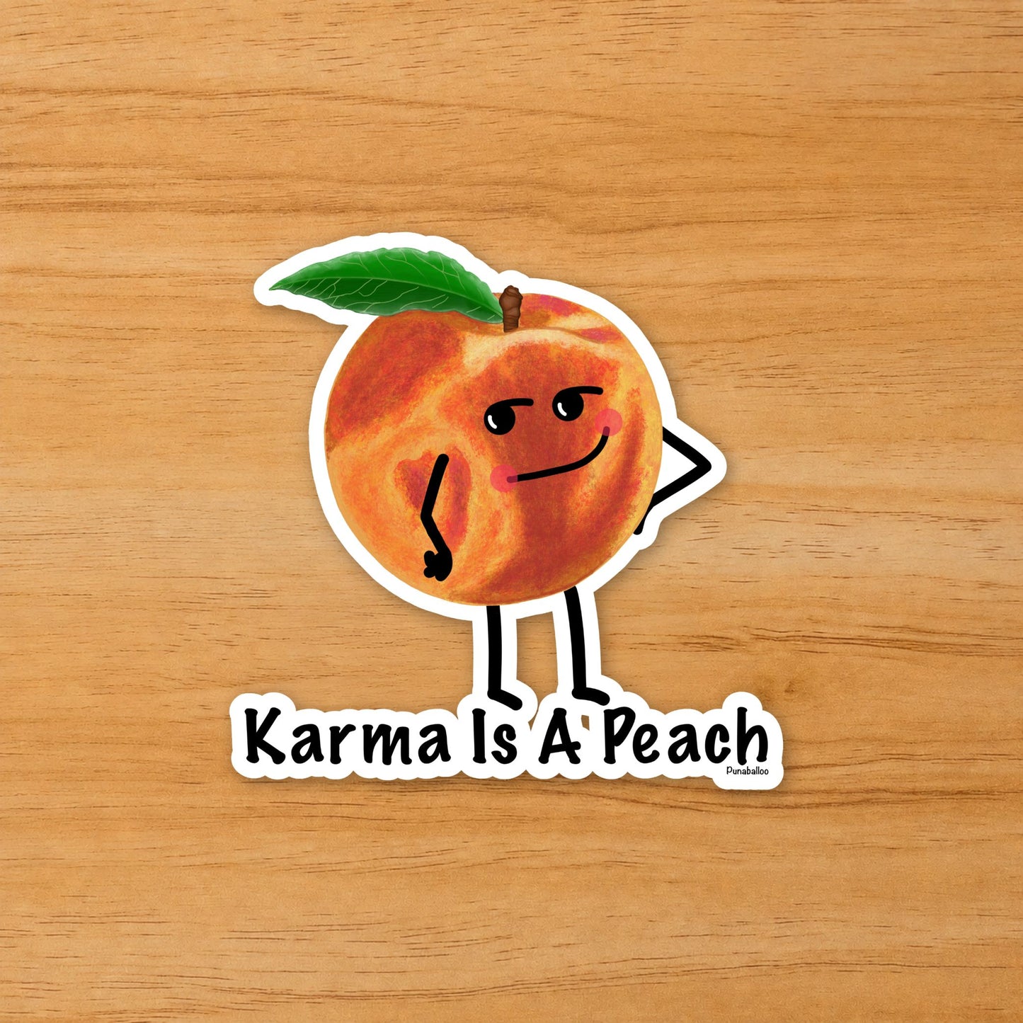 Karma Is a Peach peach pun sticker on a wood surface