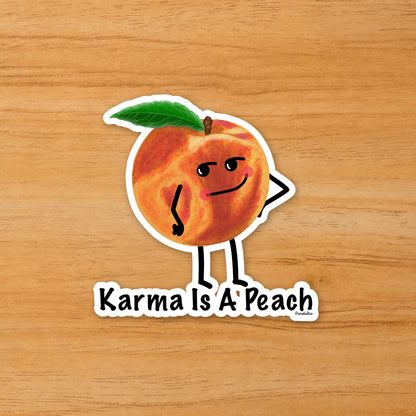 Karma Is a Peach peach pun sticker on a wood surface