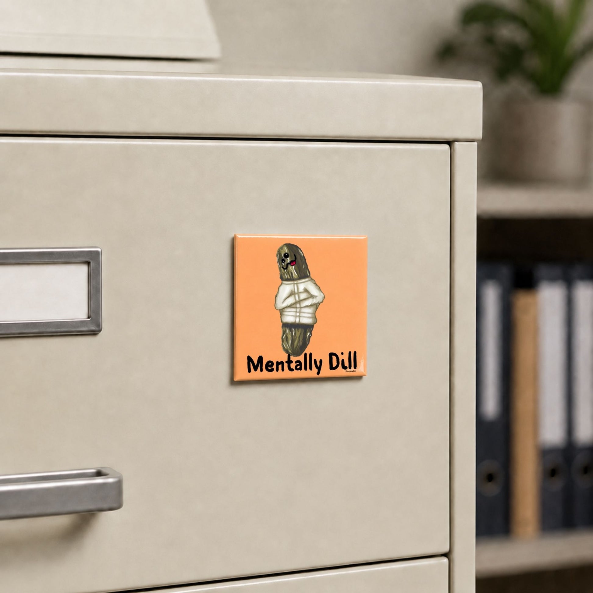 Mentally Dill funny pickle magnet on a cream file cabinet