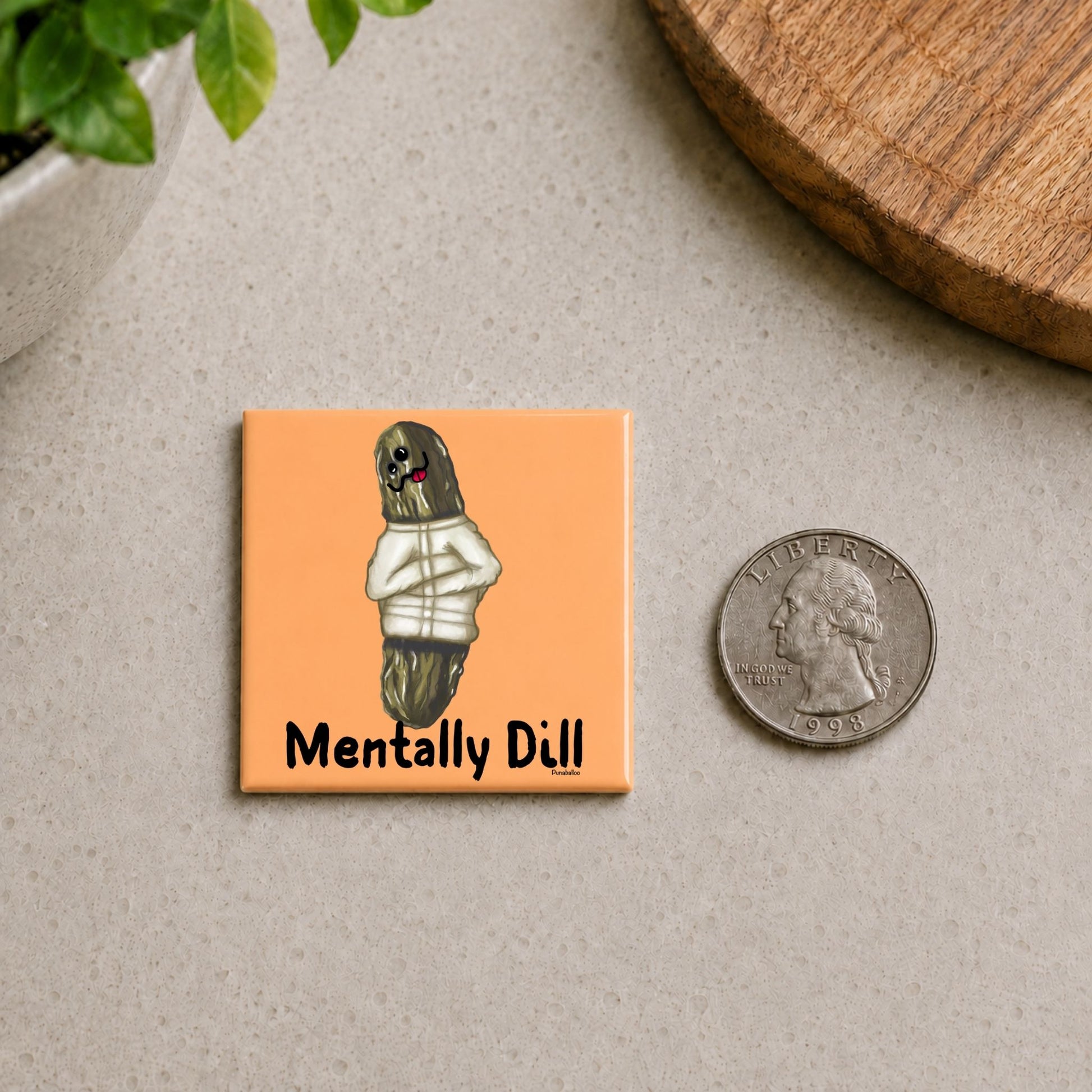Mentally Dill pickle pun magnet on a countertop beside a quarter for size