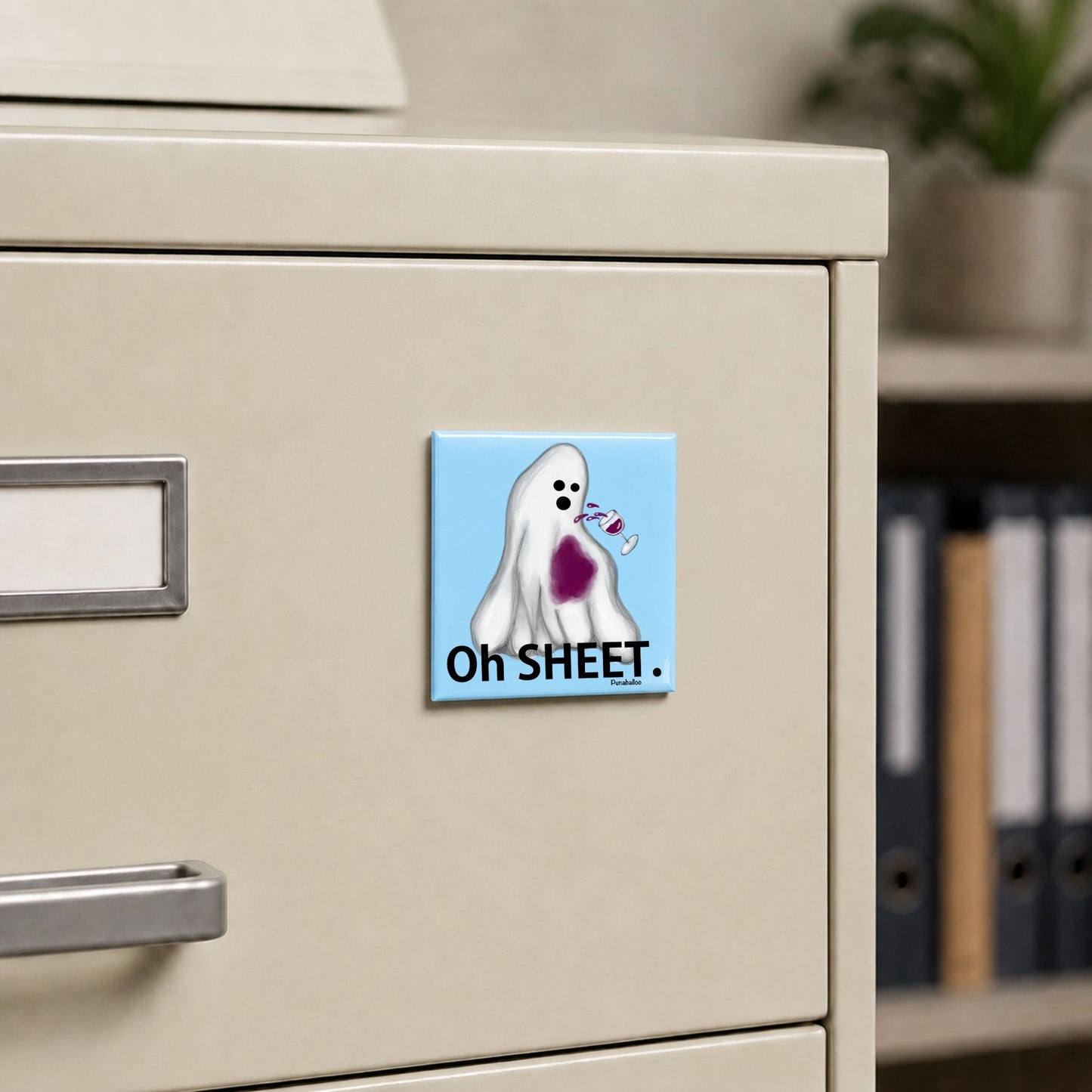 Oh Sheet ghost pun magnet on a cream file cabinet