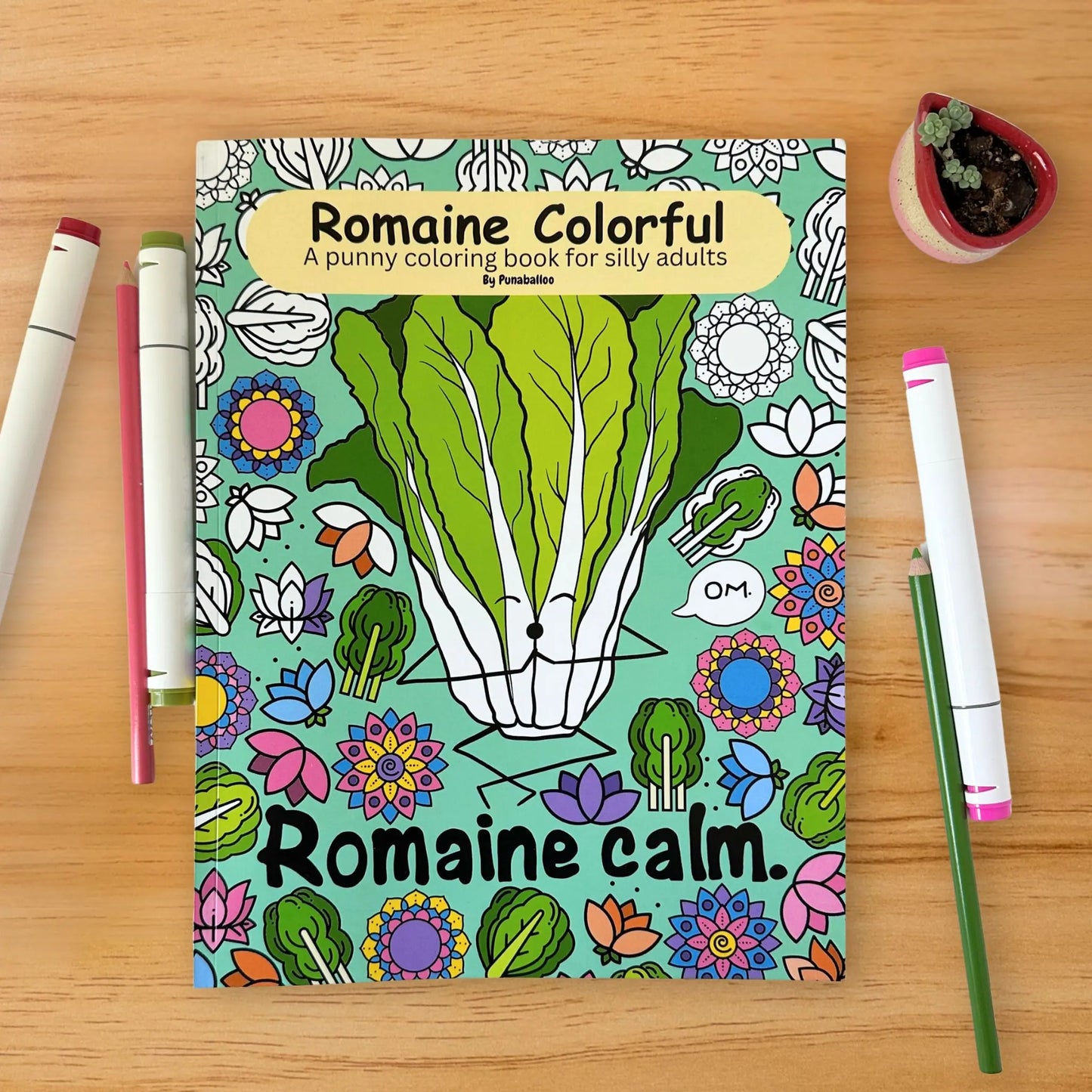Romaine Colorful adult coloring book cover with lettuce design and markers on wood background
