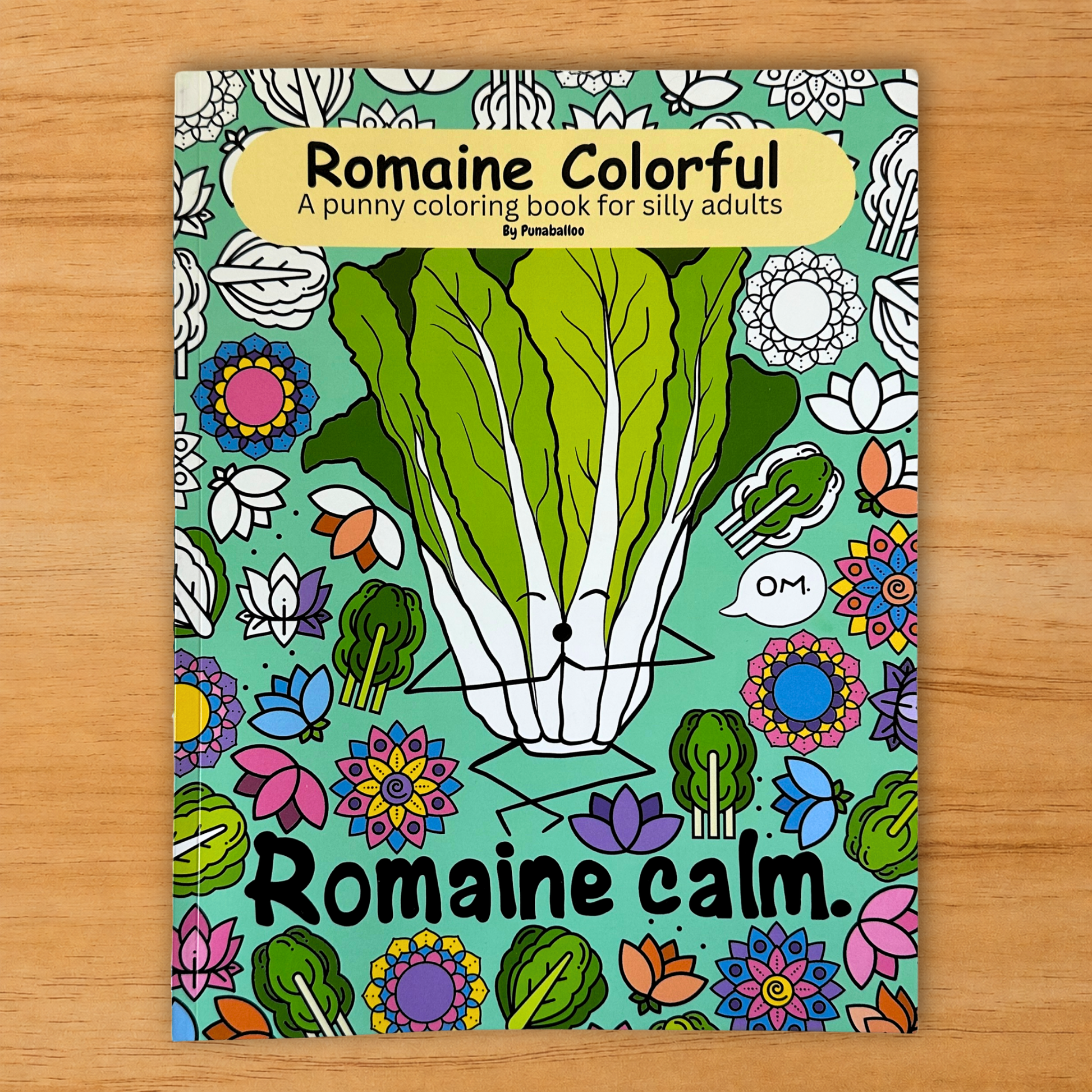 Romaine Colorful adult coloring book cover with lettuce design and markers on wood background
