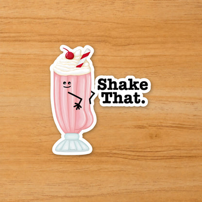 Shake That milkshake pun sticker on a wood surface