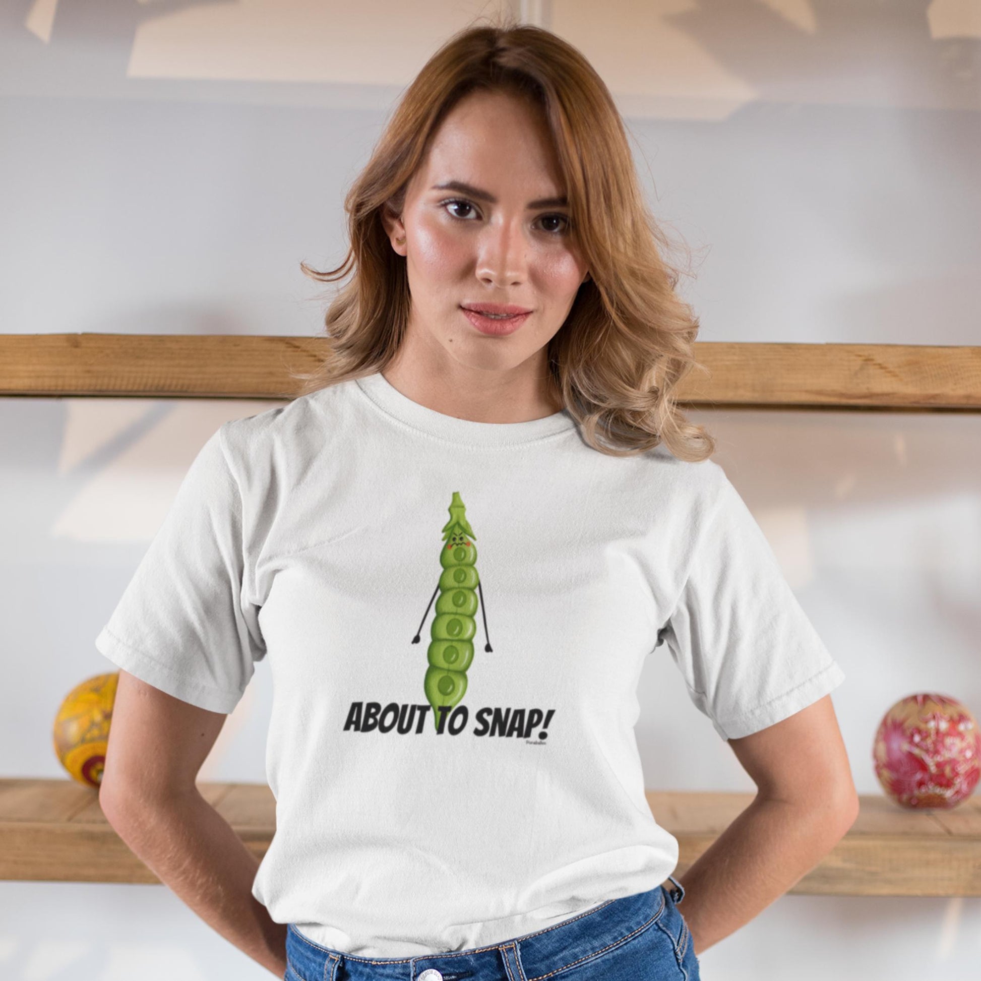Woman wearing a white I’m About to Snap funny gardening t-shirt with jeans