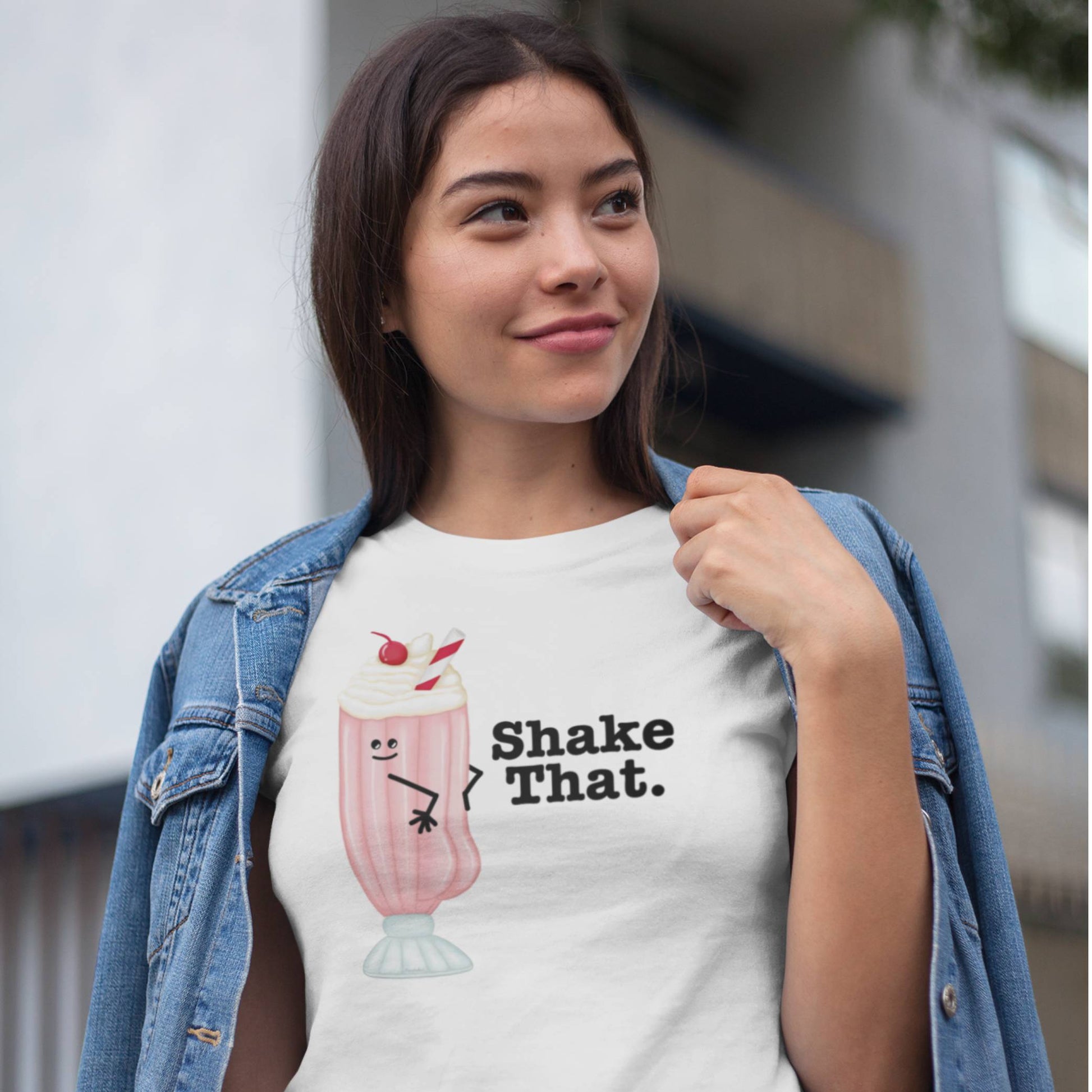 Woman wearing a white Shake That milkshake t-shirt with denim jacket